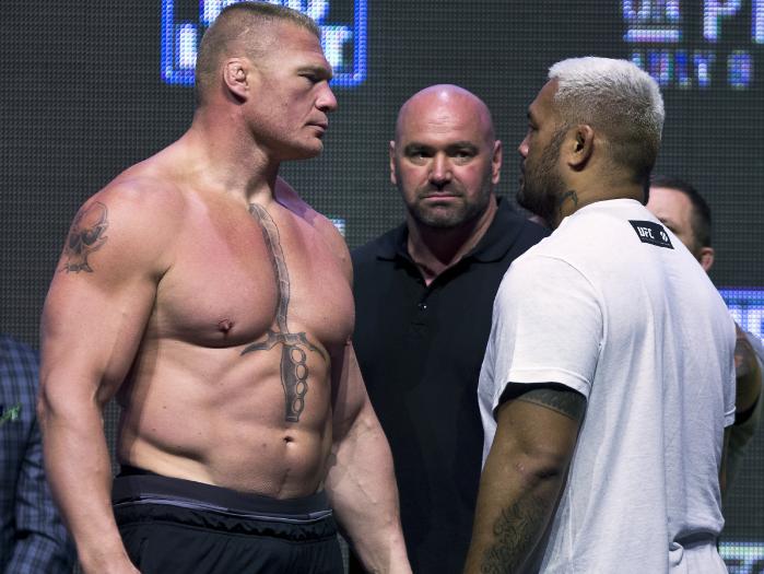Brock Lesnar looks at Mark Hunt during the UFC 200 Weigh-ins.