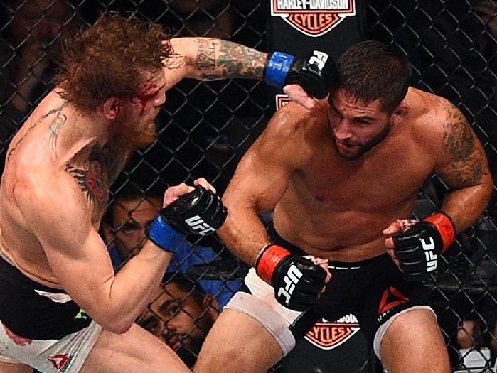 Conor Mcgregor punches Chad Mendes during their UFC 189 fight