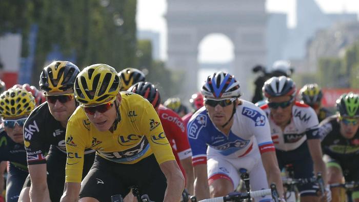 Tour de France winner Chris Froome, moves with the pack down the Champs Elysees during final stage