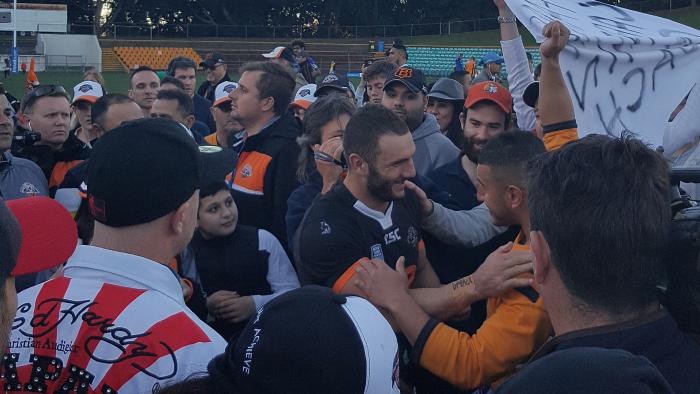 Dropped West Tigers hooker Robbie Farah is swamped by fans.