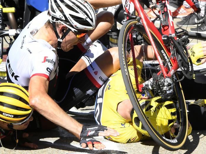 Britain's Chris Froome, wearing the overall leader's yellow jersey, right, Netherlands’ Bauke Mollema, centre, and Australia’s Richie Porte crash at the end of the twelfth stage of the Tour de France.