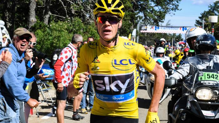 Chris Froome running to get a replacement bike after falling during the 178km 12 stage
