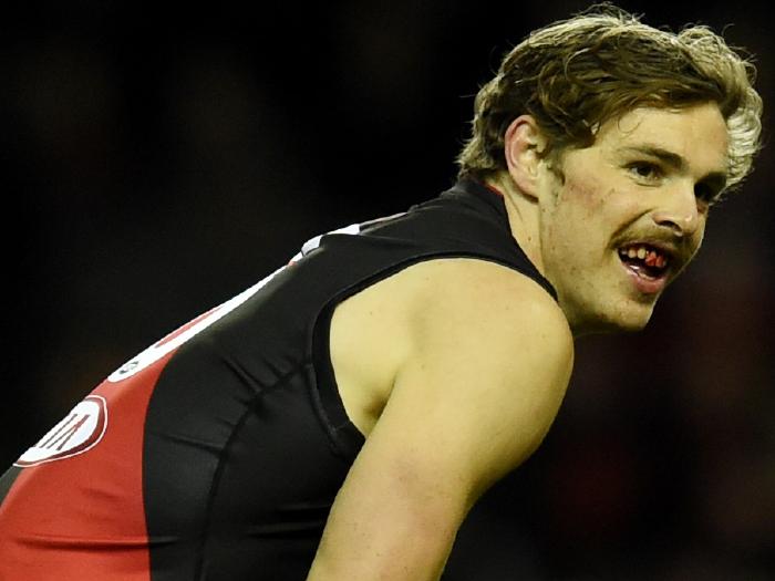 Joe Daniher bleeds from the mouth during Essendons major loss to the Lions.
