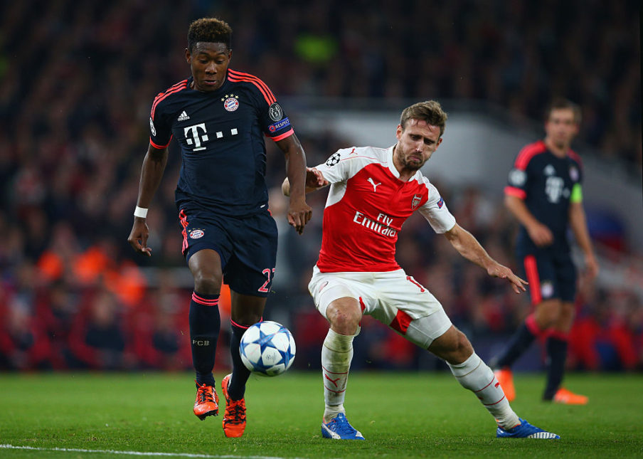 David Alaba of Bayern Munich evades Nacho Monreal of Arsenal